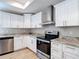 Modern kitchen with stainless steel appliances, white cabinets, and stylish countertops at 12053 Centralia Rd, Weeki Wachee, FL 34614