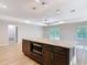 Open kitchen with island, granite counters, modern lighting, and stainless microwave at 12053 Centralia Rd, Weeki Wachee, FL 34614