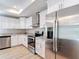 Well-equipped kitchen featuring stainless steel appliances, granite countertops, and bright white cabinetry at 12053 Centralia Rd, Weeki Wachee, FL 34614