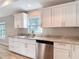 Well-lit kitchen featuring granite countertops, stainless steel appliances, and white cabinets at 12053 Centralia Rd, Weeki Wachee, FL 34614