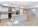 Kitchen with island featuring granite countertops, white cabinetry, and stainless steel appliances at 12053 Centralia Rd, Weeki Wachee, FL 34614