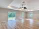 Spacious open floor plan living room with wood floors, windows, and sliding door at 12053 Centralia Rd, Weeki Wachee, FL 34614