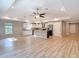 Open floorplan living room with wood floors, recessed lighting, and ceiling fan at 12053 Centralia Rd, Weeki Wachee, FL 34614