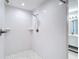 Tiled shower with dual shower heads and built-in shelving at 12053 Centralia Rd, Weeki Wachee, FL 34614