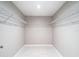 Well-organized walk-in closet with wire shelving and a neutral color scheme at 12053 Centralia Rd, Weeki Wachee, FL 34614