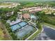 An aerial view highlights a community pool, tennis courts, and well-manicured landscaping at 20159 Umbria Hill Dr, Tampa, FL 33647