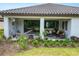 Covered back patio area with outdoor seating, hammock, and view of the landscaped yard at 20159 Umbria Hill Dr, Tampa, FL 33647