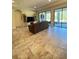 Bright living room featuring large windows, neutral tones, and access to the outdoor living area at 20159 Umbria Hill Dr, Tampa, FL 33647