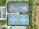 Aerial view of tennis and pickleball courts with professional surfaces in a well-maintained community at 20159 Umbria Hill Dr, Tampa, FL 33647
