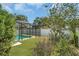 Well-maintained backyard featuring a screened pool, lush greenery, and a peaceful atmosphere at 625 Chilt Dr, Brandon, FL 33510