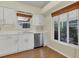 Kitchen with stainless steel dishwasher, white cabinets and sink next to a window at 625 Chilt Dr, Brandon, FL 33510