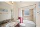 Well-lit bathroom features granite countertop, shower-tub combo with tiled walls, and a window at 727 Vineyard Reserve Ct, Seffner, FL 33584