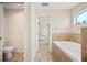 Ensuite bathroom with tiled shower, soaking tub, and a view into the bedroom at 727 Vineyard Reserve Ct, Seffner, FL 33584