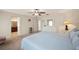 Bright bedroom with a ceiling fan, carpet, and a glimpse into the ensuite bathroom at 727 Vineyard Reserve Ct, Seffner, FL 33584