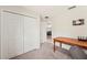 Bright bedroom features carpeted floors, closet, wooden desk and a view of connecting room at 727 Vineyard Reserve Ct, Seffner, FL 33584