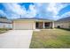 Charming one-story home featuring a two-car garage, well-maintained lawn, and a screened-in front porch at 727 Vineyard Reserve Ct, Seffner, FL 33584