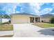 Charming one-story home featuring a two-car garage, well-maintained lawn, and a screened-in front porch at 727 Vineyard Reserve Ct, Seffner, FL 33584