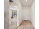 Hallway with neutral wall paint, tiled floors and white doors at 727 Vineyard Reserve Ct, Seffner, FL 33584