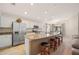 Stylish kitchen featuring a breakfast bar, stainless steel appliances, and granite countertops, perfect for cooking and entertaining at 727 Vineyard Reserve Ct, Seffner, FL 33584