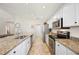 Bright kitchen with stainless steel appliances, granite countertops, and ample cabinet space at 727 Vineyard Reserve Ct, Seffner, FL 33584