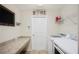Functional laundry room equipped with modern washer and dryer, offering convenience and efficiency at 727 Vineyard Reserve Ct, Seffner, FL 33584
