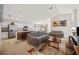 Open-concept living room and kitchen featuring stainless appliances, breakfast bar, and comfortable seating at 727 Vineyard Reserve Ct, Seffner, FL 33584