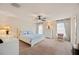 Serene bedroom with neutral colors, ceiling fan, and large windows creating a relaxing retreat at 727 Vineyard Reserve Ct, Seffner, FL 33584