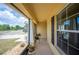 Screened porch with view of the landscaped yard and street at 727 Vineyard Reserve Ct, Seffner, FL 33584
