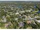 Wide aerial view displays a residential community among the lakes with tree-lined streets, nearby houses, and lush landscaping at 7313 Crape Myrtle Way, Sarasota, FL 34241