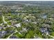 Wide aerial shot shows property nestled among trees and lakes in the community, with other houses nearby at 7313 Crape Myrtle Way, Sarasota, FL 34241