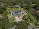Overhead view of property shows mature landscaping surrounding home with dark roof, solar panels, and defined property lines at 7313 Crape Myrtle Way, Sarasota, FL 34241