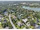 Aerial photo of home nestled among trees and lakes in a residential community with other houses nearby at 7313 Crape Myrtle Way, Sarasota, FL 34241