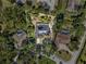 Aerial shot of the home and its surroundings with a pool and lots of mature landscaping and defined property lines at 7313 Crape Myrtle Way, Sarasota, FL 34241