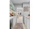 Chic bar area with countertop, glass cabinet, and access to the kitchen at 7313 Crape Myrtle Way, Sarasota, FL 34241