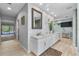 Bright bathroom with double vanity, and decorative textured wall at 7313 Crape Myrtle Way, Sarasota, FL 34241