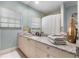 Bright bathroom with a large mirror, granite countertop, and window for natural light at 7313 Crape Myrtle Way, Sarasota, FL 34241