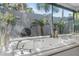 Close up of bathroom soaking tub surrounded by mirrors with views of the backyard at 7313 Crape Myrtle Way, Sarasota, FL 34241