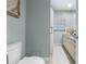 Well-lit bathroom featuring a vanity, toilet, and shower with a shower curtain at 7313 Crape Myrtle Way, Sarasota, FL 34241