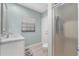 Bathroom featuring a vanity with marble countertop and a glass-enclosed shower at 7313 Crape Myrtle Way, Sarasota, FL 34241