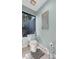 Bathroom featuring a toilet and window overlooking exterior foliage at 7313 Crape Myrtle Way, Sarasota, FL 34241