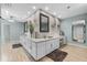 Bathroom featuring double sinks, decorative wall, and modern fixtures at 7313 Crape Myrtle Way, Sarasota, FL 34241
