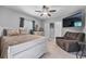 Cozy bedroom with comfortable armchair, and a queen bed with neutral colored bedding at 7313 Crape Myrtle Way, Sarasota, FL 34241