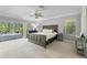 Spacious bedroom features neutral carpet, ceiling fan and direct access to outdoor patio at 7313 Crape Myrtle Way, Sarasota, FL 34241