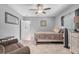 Bright bedroom with a queen bed, ceiling fan, and carpet floors at 7313 Crape Myrtle Way, Sarasota, FL 34241
