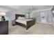 This bedroom features plush neutral carpet, ceiling fan, and ample natural light at 7313 Crape Myrtle Way, Sarasota, FL 34241