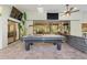 Bright game room with a pool table, ceiling fan, large glass doors and ample seating for entertaining at 7313 Crape Myrtle Way, Sarasota, FL 34241