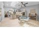 This open-concept kitchen has stainless steel appliances, a large island, a glass table, and a view of the dining room at 7313 Crape Myrtle Way, Sarasota, FL 34241