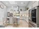 This modern kitchen features white cabinets, stainless steel appliances, a skylight, and a kitchen island with seating at 7313 Crape Myrtle Way, Sarasota, FL 34241