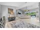Bright and spacious open-concept living room with tile flooring and large windows at 7313 Crape Myrtle Way, Sarasota, FL 34241