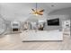 Open living space with modern fan, large TV, and neutral palette leading to dining area at 7313 Crape Myrtle Way, Sarasota, FL 34241